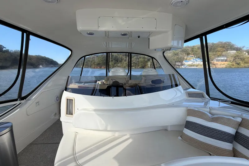 Slide: The Image of Interior view of 2003 Sea Ray 560 Sedan Bridge yacht with scenic water backdrop. - 18