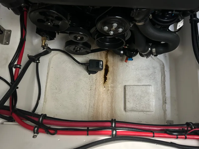 Slide: The Image of Engine compartment of 2024 Cobalt R6 with cables and oil stains. - 28