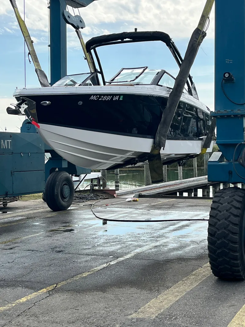 Slide: The Image of 2024 Cobalt R6 boat being lowered into water by crane. - 47