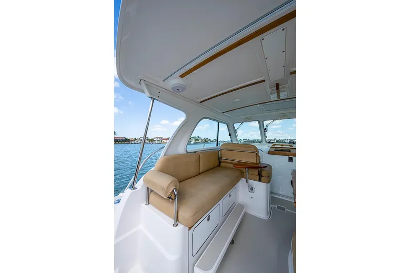 Slide: The Image of Interior of 2011 Back Cove 30 boat with beige seating and water view. - 11