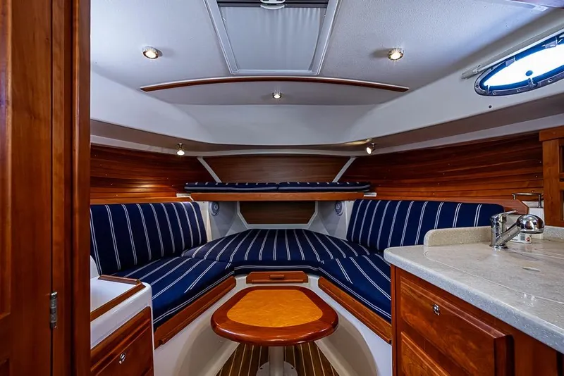 Slide: The Image of Interior of 2011 Back Cove 30 boat with striped seating and wooden accents. - 16