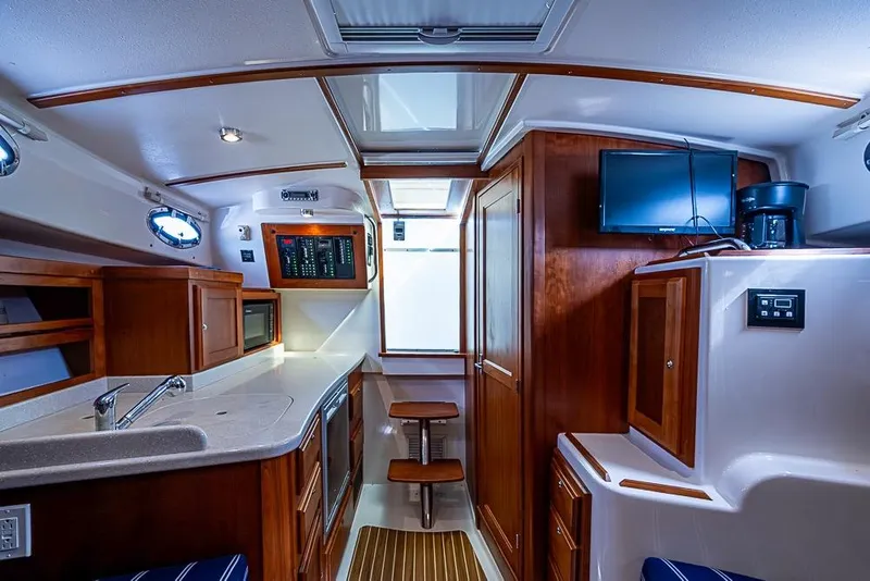 Slide: The Image of Interior of a 2011 Back Cove 30 boat with modern kitchen and wooden cabinetry. - 20