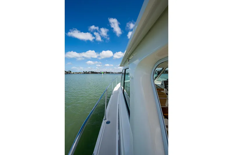 Slide: The Image of 2011 Back Cove 30 yacht cruising on calm waters under a clear blue sky. - 23