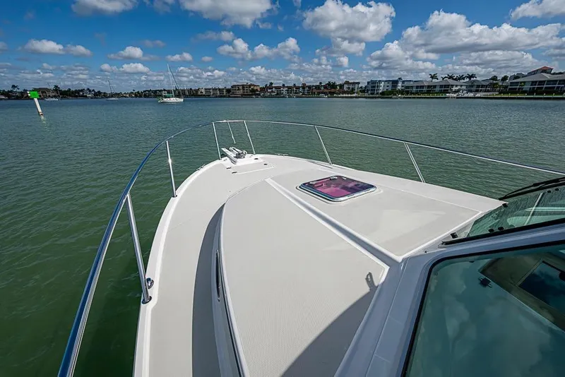 Slide: The Image of 2011 Back Cove 30 boat on calm water under a partly cloudy sky. - 24