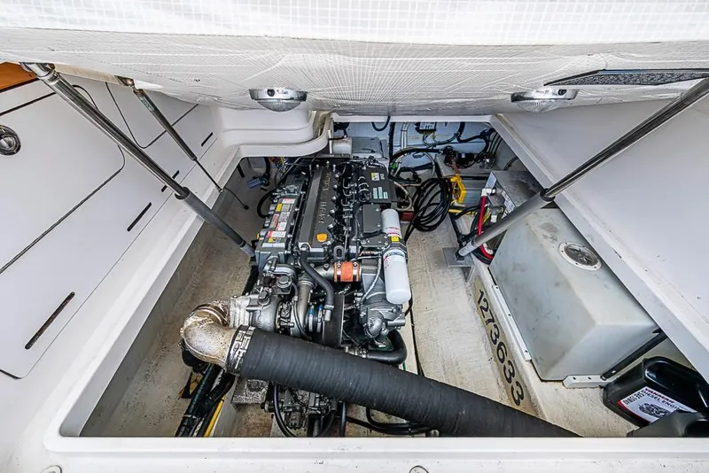 Slide: The Image of Engine compartment of a 2011 Back Cove 30 boat, showcasing detailed mechanical components. - 28