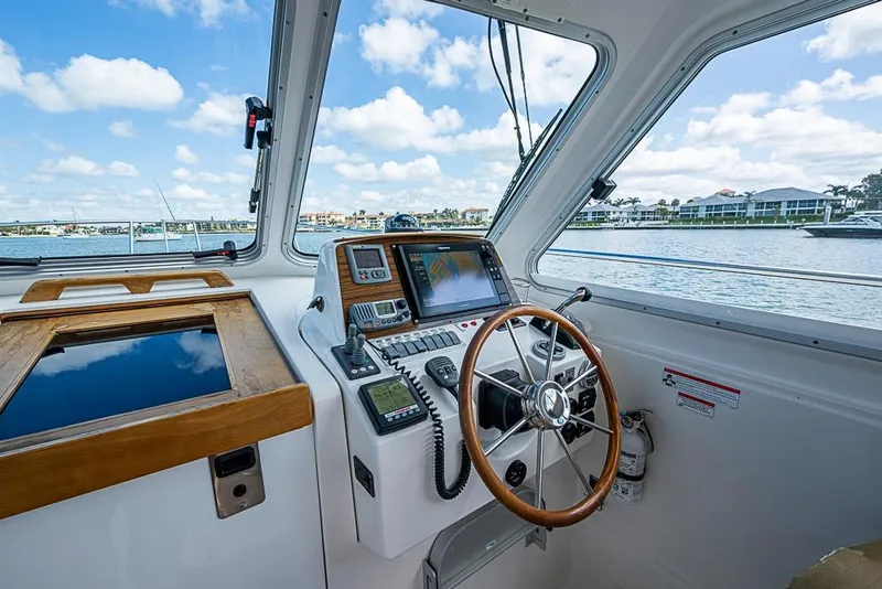 Slide: The Image of Helm of 2011 Back Cove 30 boat with navigation equipment and scenic water view. - 5