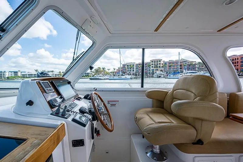 Slide: The Image of Interior of 2011 Back Cove 30 boat with helm station and leather seating. - 7