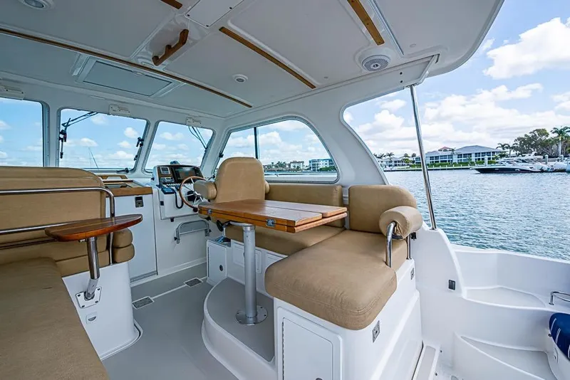Slide: The Image of Interior of 2011 Back Cove 30 boat with beige seating and wooden accents. - 9