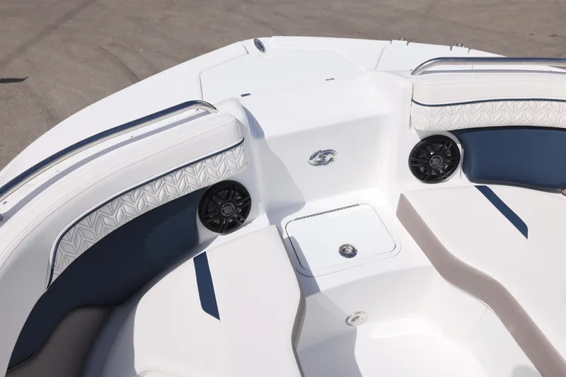 Slide: The Image of 2026 Hurricane SunDeck 2400 OB boat interior with cushioned seating and built-in speakers. - 10