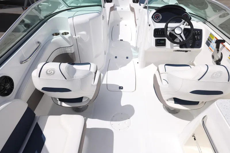 Slide: The Image of 2026 Hurricane SunDeck 2400 OB boat interior with white seating and modern dashboard. - 2
