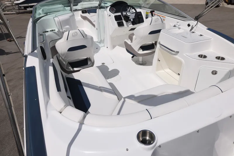 Slide: The Image of 2026 Hurricane SunDeck 2400 OB boat interior with seating and helm station. - 21
