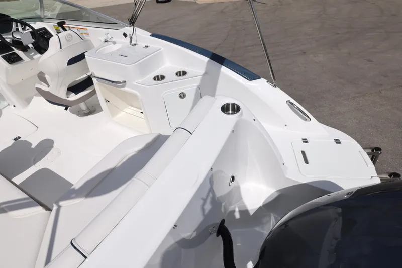 Slide: The Image of 2026 Hurricane SunDeck 2400 OB boat interior with seating, helm, and cup holders. - 22