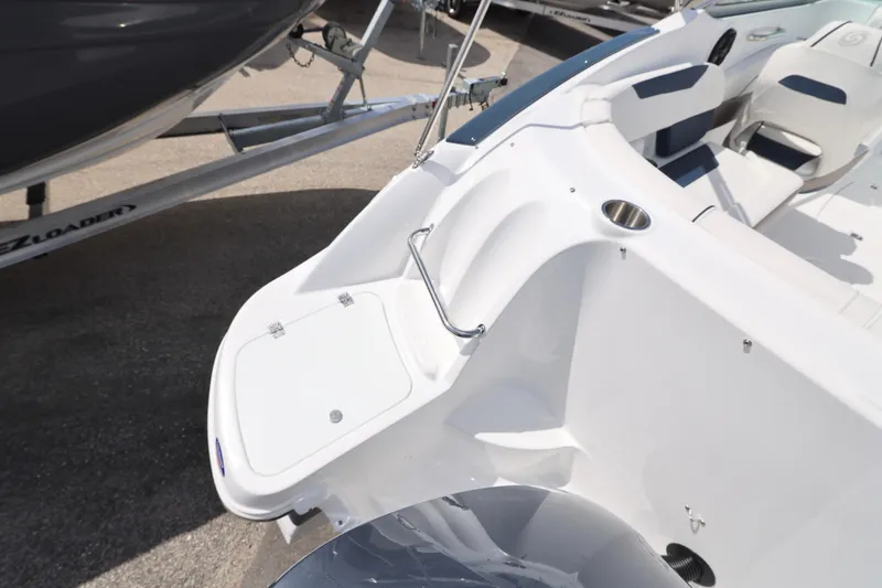 Slide: The Image of 2026 Hurricane SunDeck 2400 OB boat interior with seating and storage compartment. - 23