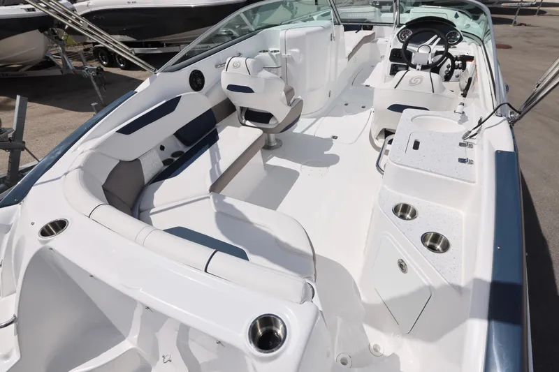 Slide: The Image of 2026 Hurricane SunDeck 2400 OB boat interior with seating and steering console. - 24