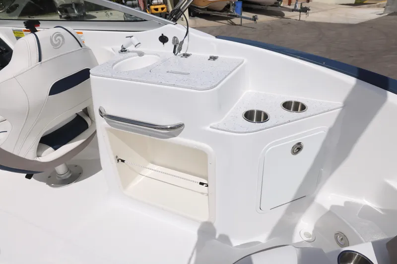 Slide: The Image of 2026 Hurricane SunDeck 2400 OB boat interior with sink, cup holders, and seating. - 5
