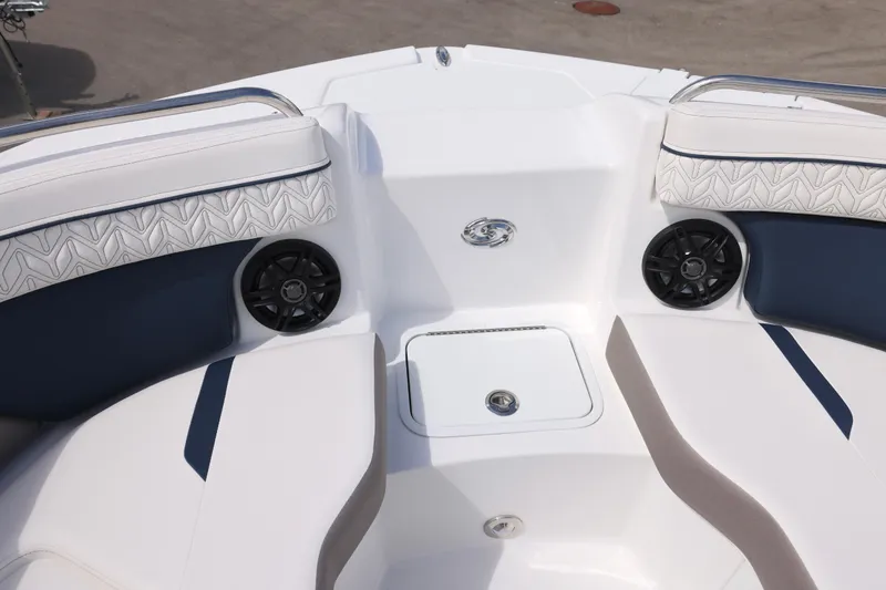 Slide: The Image of 2026 Hurricane SunDeck 2400 OB boat interior with cushioned seating and speakers. - 9