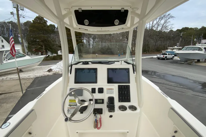 Slide: The Image of 2019 Century 2301 Center Console boat dashboard with steering wheel and navigation screens. - 11