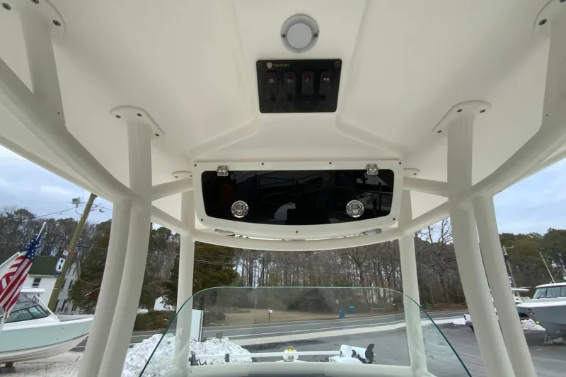 Slide: The Image of 2019 Century 2301 Center Console boat interior with T-top and control panel. - 13