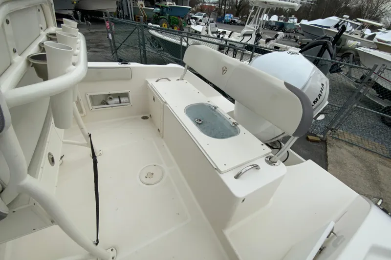Slide: The Image of 2019 Century 2301 Center Console boat interior with Yamaha engine, docked outdoors. - 16