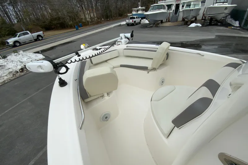 Slide: The Image of 2019 Century 2301 Center Console boat with seating and trolling motor, parked outdoors. - 19