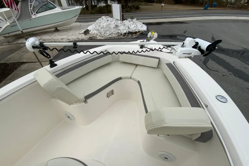 Slide: The Image of 2019 Century 2301 Center Console boat with cushioned seating and Minn Kota trolling motor. - 20
