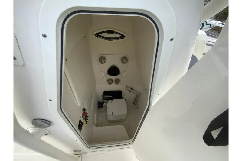 Slide: The Image of 2019 Century 2301 Center Console boat interior with compact marine toilet. - 23
