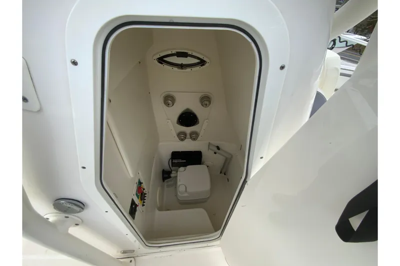 Slide: The Image of 2019 Century 2301 Center Console boat interior with compact marine toilet. - 24