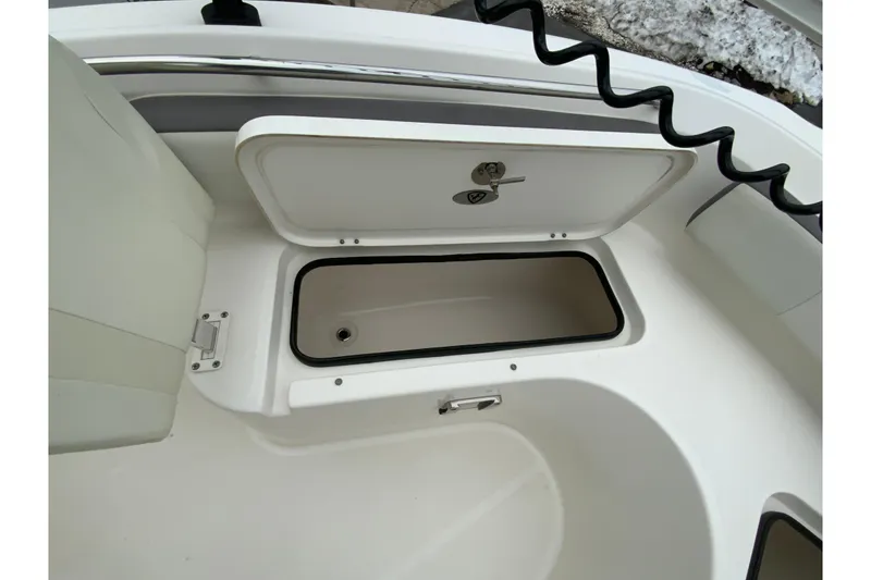 Slide: The Image of 2019 Century 2301 Center Console boat storage compartment with open hatch. - 27