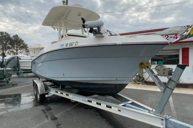 Slide: The Image of 2019 Century 2301 Center Console boat on trailer, parked outdoors. - 3