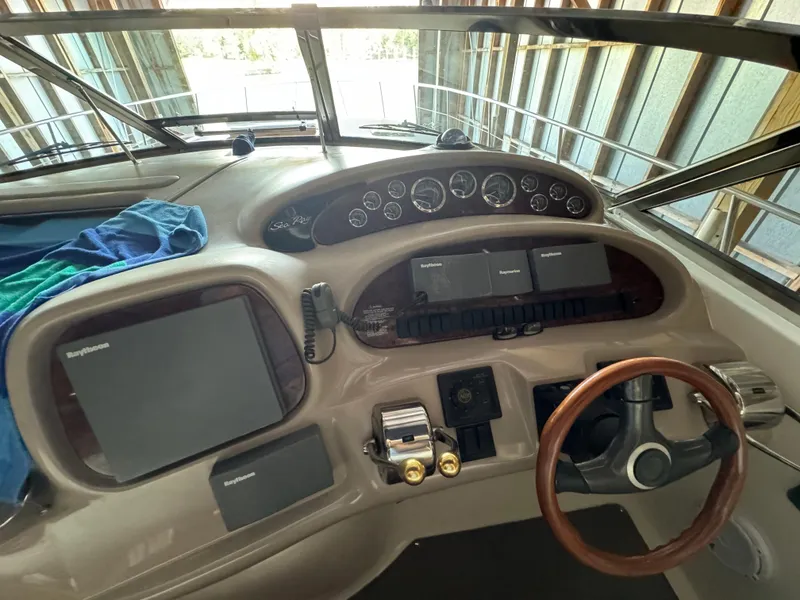 Slide: The Image of Sea Ray 380 Sundancer 2000 helm with navigation instruments and steering wheel. - 5
