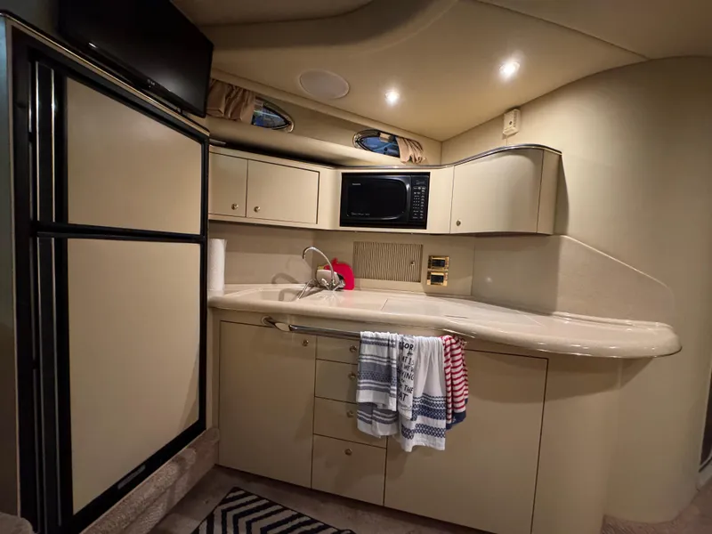 Slide: The Image of Interior of 2000 Sea Ray 380 Sundancer yacht kitchen with modern amenities. - 6