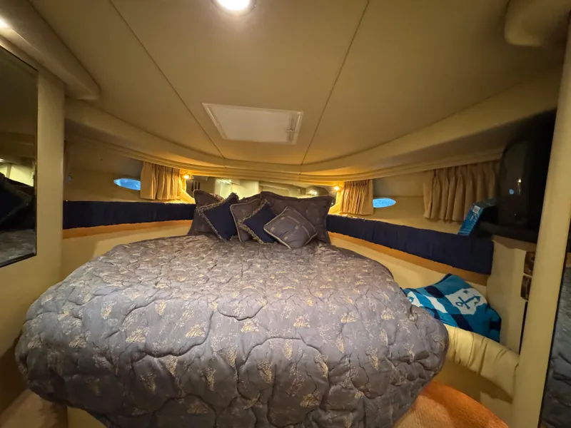 Slide: The Image of Cozy cabin interior of 2000 Sea Ray 380 Sundancer with plush bedding. - 9