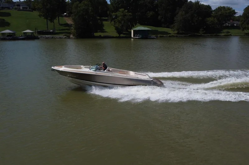 The Image of 2019 Chris-Craft Launch 30 speedboat cruising on a serene lake. - 0