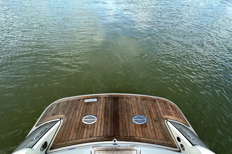 Slide: The Image of 2019 Chris-Craft Launch 30 boat with wooden deck on calm water. - 14