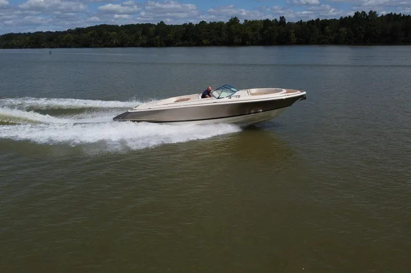 Slide: The Image of 2019 Chris-Craft Launch 30 speeding on a lake under a partly cloudy sky. - 2