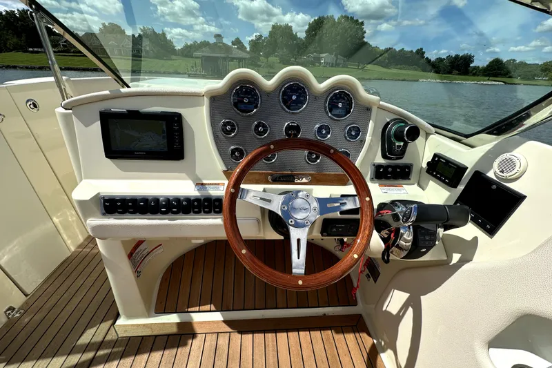 Slide: The Image of 2019 Chris-Craft Launch 30 dashboard with wooden steering wheel and navigation system. - 9