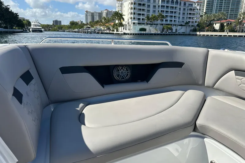 Slide: The Image of 2022 Four Winns HD8 OB boat interior with luxurious seating by the water. - 12