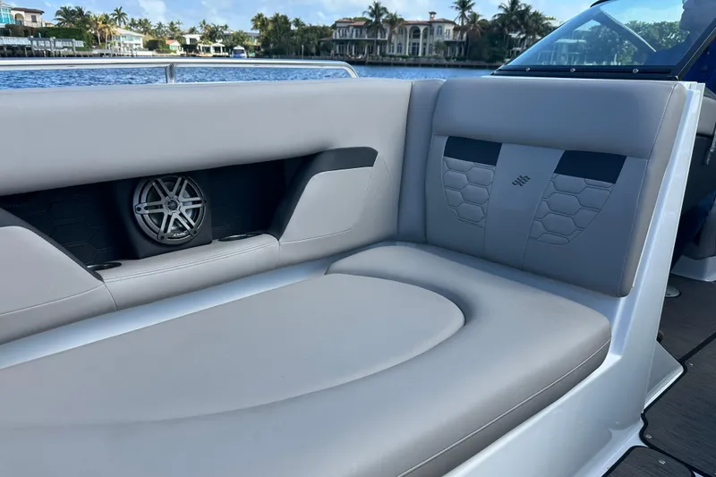 Slide: The Image of 2022 Four Winns HD8 OB boat interior with cushioned seating and built-in speaker. - 15