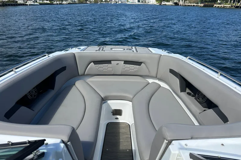 Slide: The Image of 2022 Four Winns HD8 OB boat with spacious gray seating on calm water. - 17