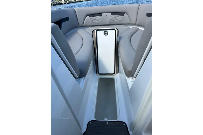 Slide: The Image of 2022 Four Winns HD8 OB boat interior with gray seating and storage compartment. - 19