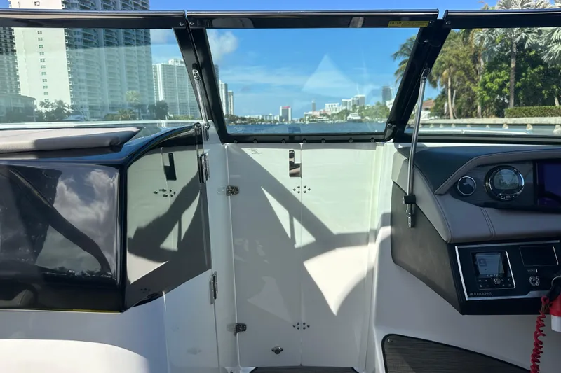 Slide: The Image of Interior view of 2022 Four Winns HD8 OB boat with cityscape in background. - 23