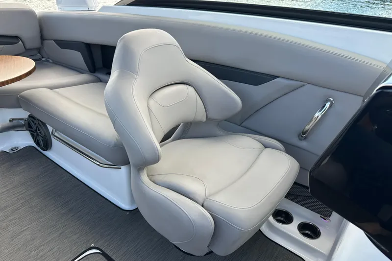 Slide: The Image of 2022 Four Winns HD8 OB boat interior with gray seating and table. - 31