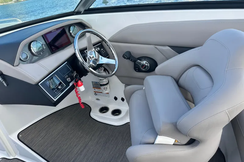 Slide: The Image of 2022 Four Winns HD8 OB boat interior with steering wheel and control panel. - 33