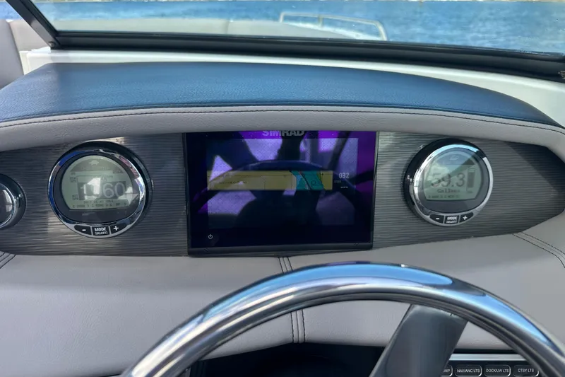 Slide: The Image of 2022 Four Winns HD8 OB boat dashboard with digital displays and steering wheel. - 34