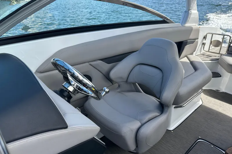 Slide: The Image of 2022 Four Winns HD8 OB boat interior with sleek steering wheel and comfortable seating. - 35