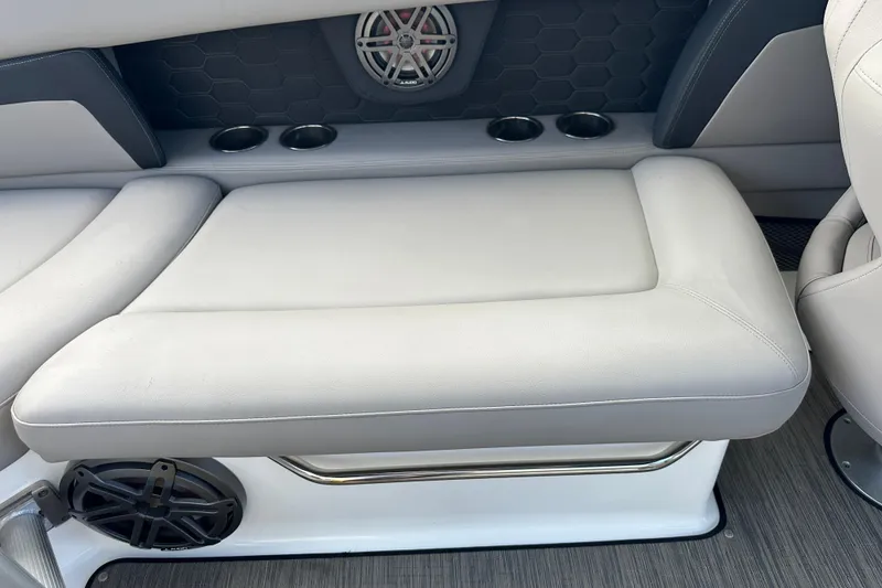 Slide: The Image of 2022 Four Winns HD8 OB boat interior with cushioned seating and cup holders. - 37