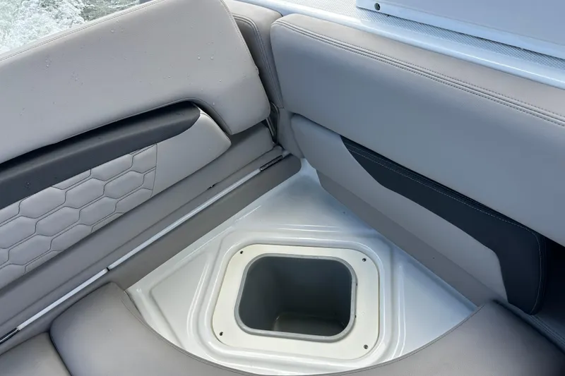 Slide: The Image of 2022 Four Winns HD8 OB boat interior with gray seating and storage compartment. - 40