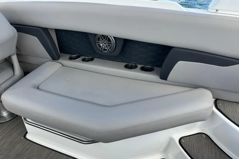 Slide: The Image of 2022 Four Winns HD8 OB boat interior with cushioned seating and cup holders. - 43