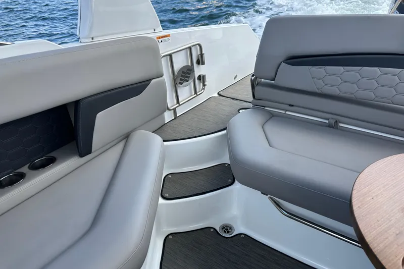 Slide: The Image of 2022 Four Winns HD8 OB boat interior with sleek gray seating and modern design. - 47