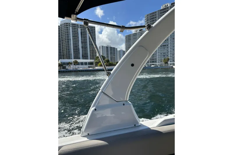 Slide: The Image of 2022 Four Winns HD8 OB boat on water with city skyline in background. - 49